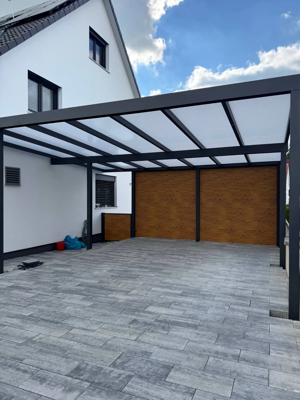 Carport mit Holzoptik-Rückwand und lichtdurchlässigem Dach